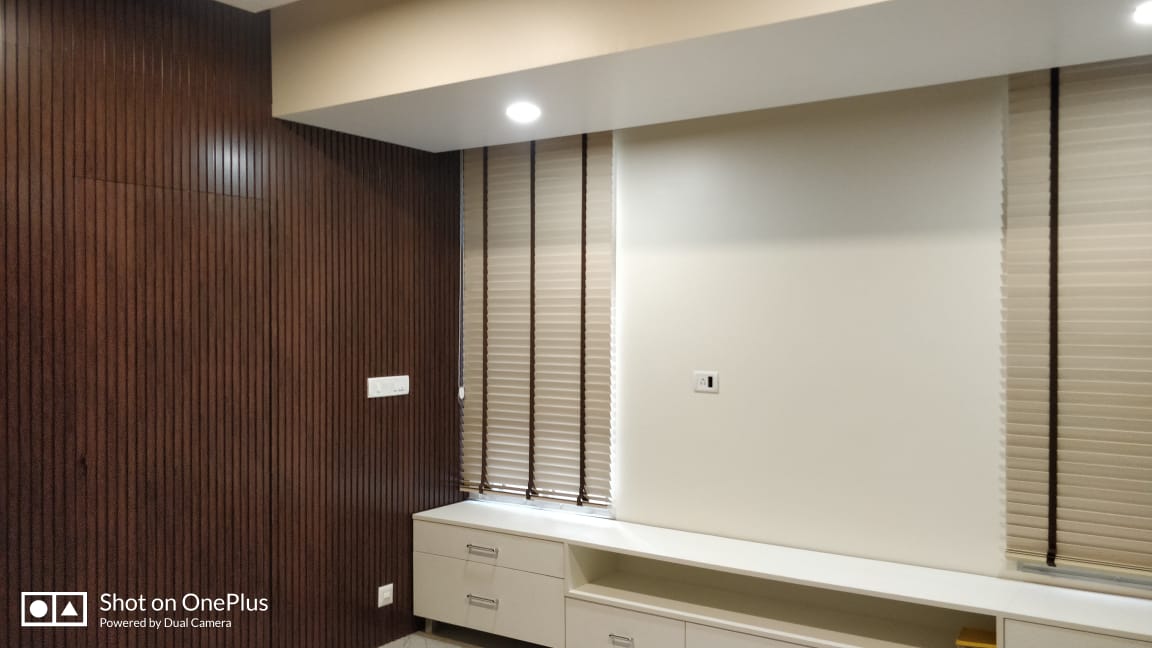 Living room TV wall with wooden slats and storage unit